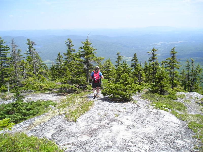 Meader (22).JPG - Danielle crossing the ledges on the way back down the trail. There was lots of haze and smoke in Maine due to some fires in Canada.